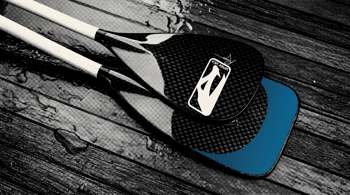 A Viper Va'a Round blade laid over a Square blade on a wet deck. The square blade's extra face shows in ocean blue. Same width, more surface area.
