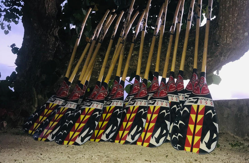 Custom crew batch of matched paddles under a Ra'iātea tree — photo @vipervaa