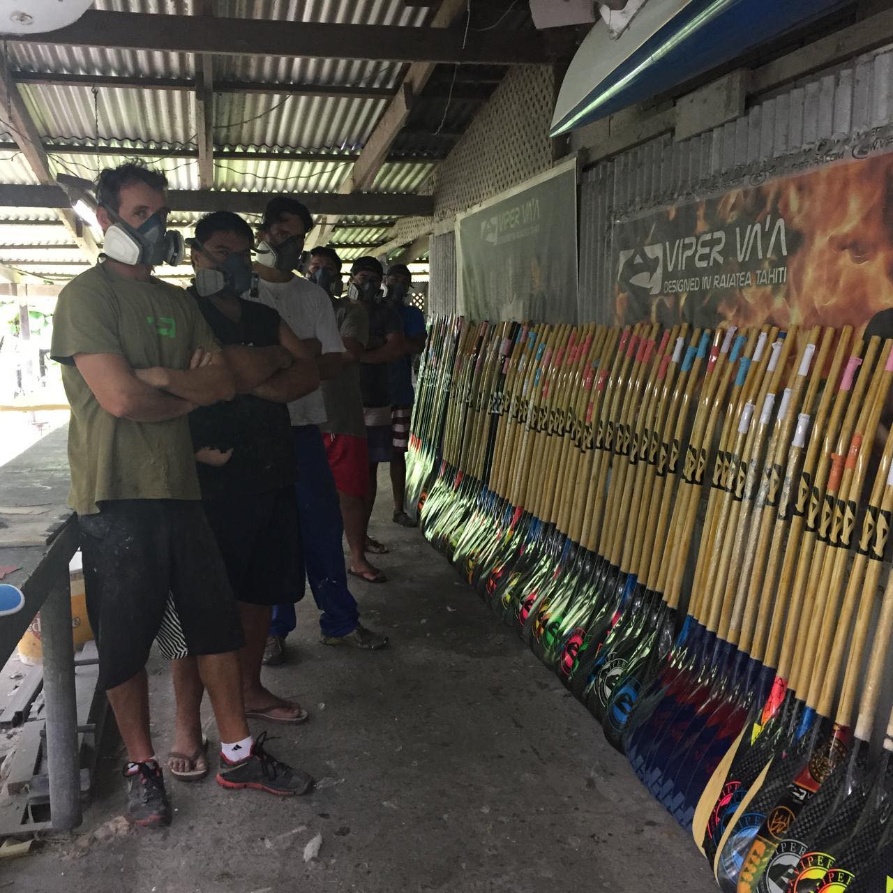 Viper Va'a workshop crew in respirators before the paddle wall — photo @vipervaa
